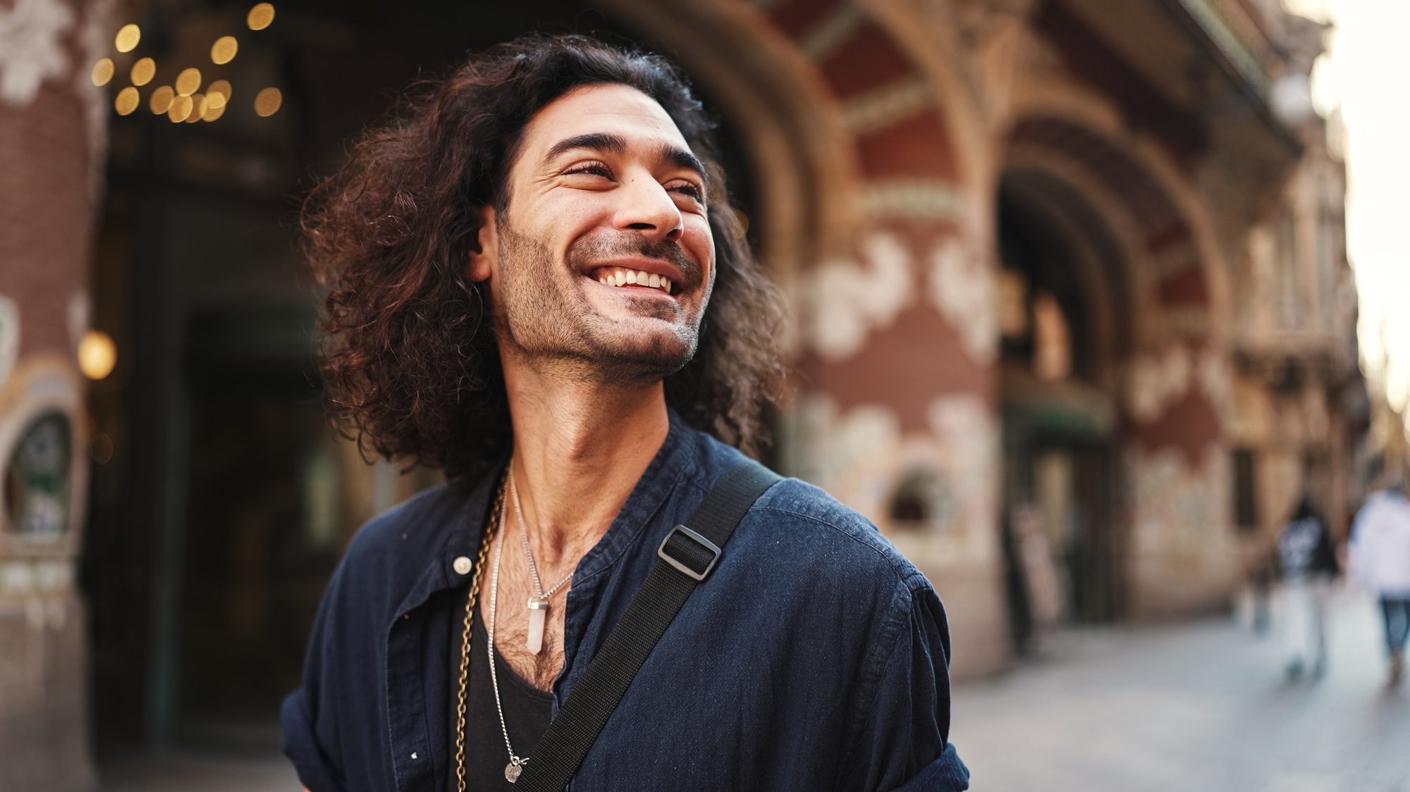 Portrait of young italian guy with long curly hair