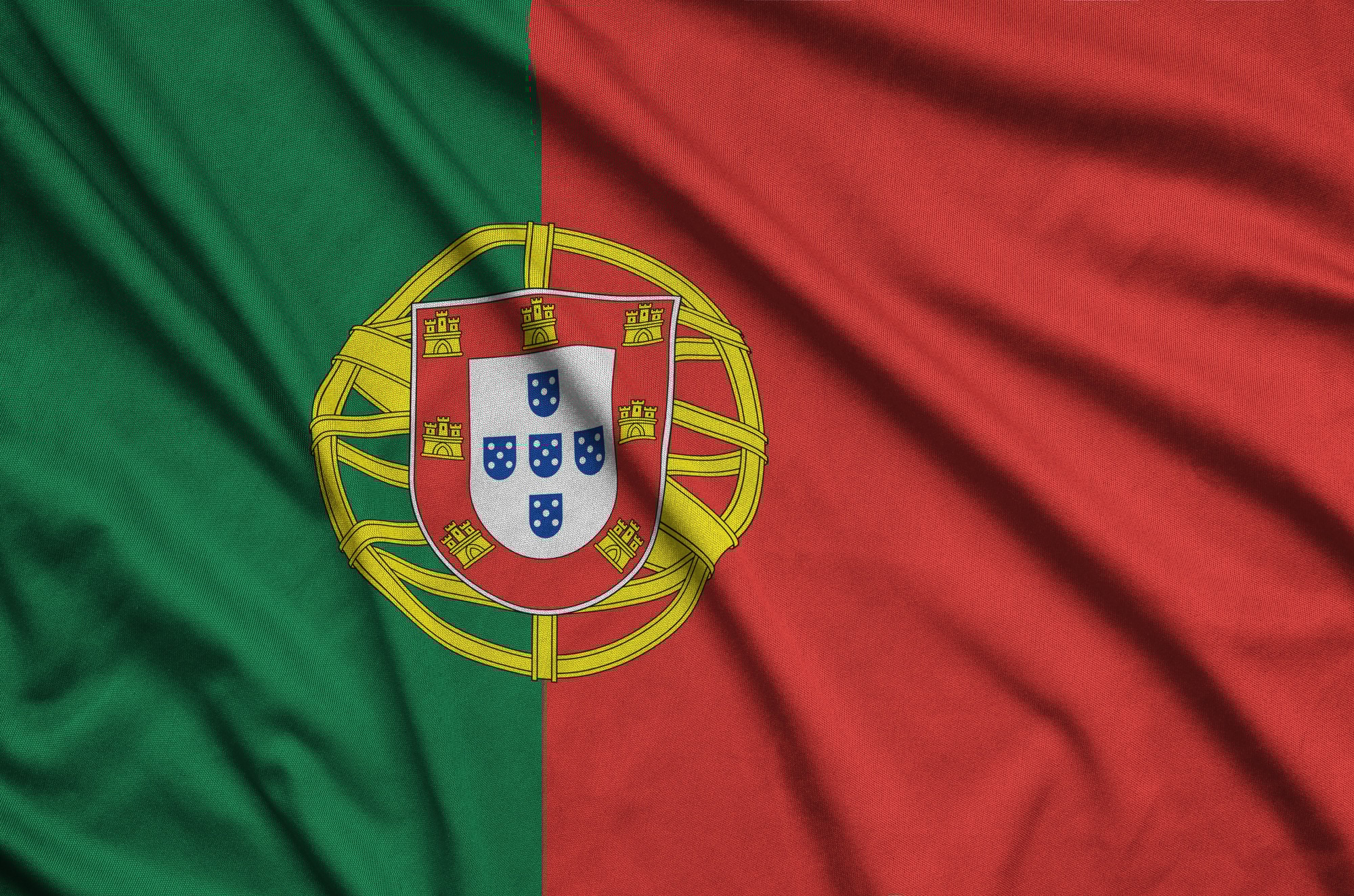 Portugal flag is depicted on a sports cloth fabric with many folds. Sport team waving banner