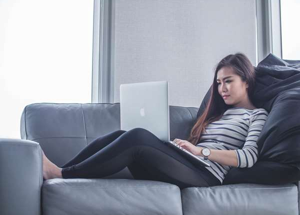 Student relaxing at home and enjoying a language lesson online